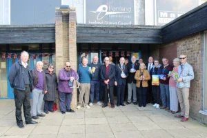 Founder and Chair of Whittlesey Emergency Food Aid, Cllr David Mason (eighth from right) and Fenland District Council Chair, Cllr Alex Miscandlon (tenth from right) join volunteers and other individuals who helped make the service's move to larger premises possible, at its official relaunch at The Manor Leisure Centre.