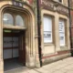 The former Post Office building which dates to the 19th century has a three-storey frontage to Bridge Street and side elevation facing Post Office Lane which lies to the east.