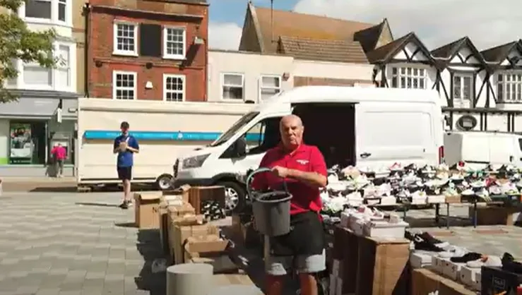 CAPTION This was the moment a stall holder lost his cool – and ‘cooled down’ a street preacher by throwing a bucket of water over him. Police have launched an inquiry. 