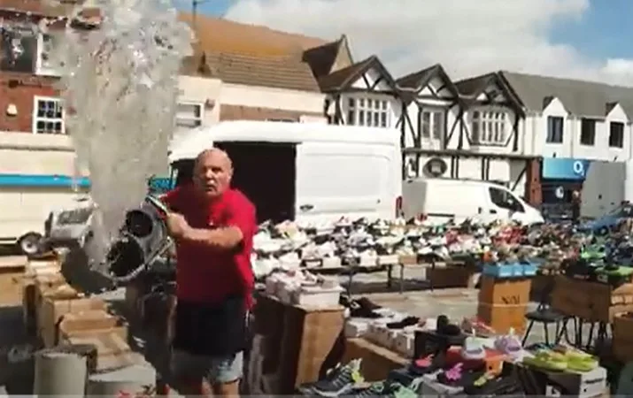 CAPTION This was the moment a stall holder lost his cool – and ‘cooled down’ a street preacher by throwing a bucket of water over him. Police have launched an inquiry. 