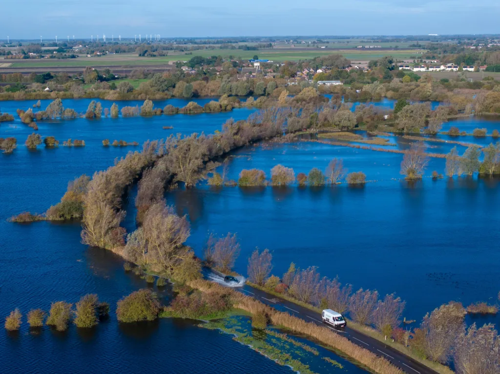 A1101 at Welney where many have chosen to find alternative routes today as water levels rise and most motorists have avoided, including those who attempted to cross but changed their mind. Bigger vehicles are still going through. PHOTO: Terry Harris for CambsNews 