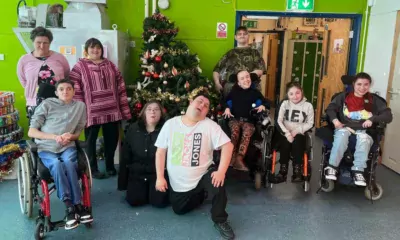 FACET students all smiles as they show off their own wonky Christmas tree