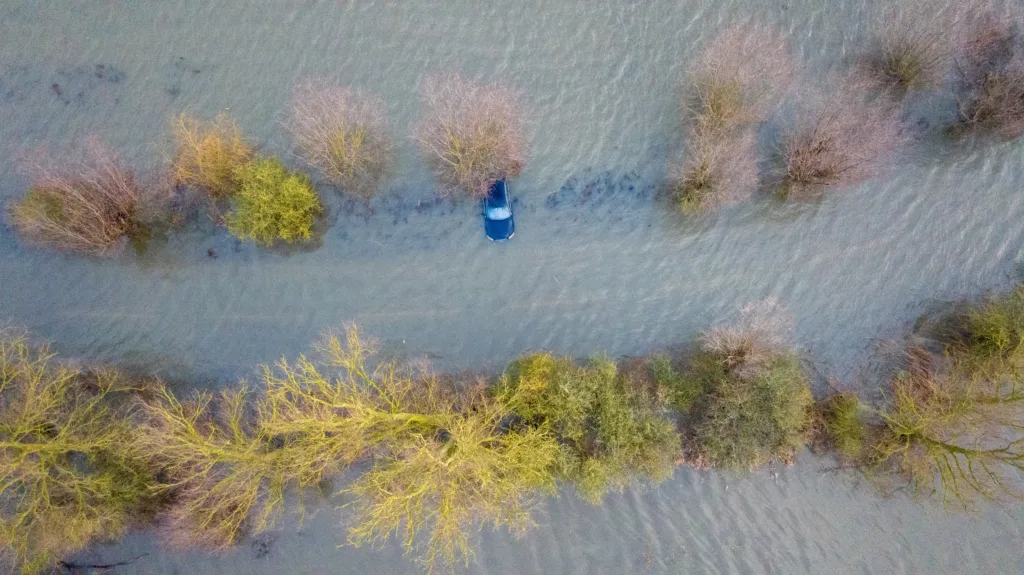 Abandoned car on the flooded A1101 in Welney, Norfolk, on Wednesday morning as the flooding continues after the recent heavy rain. PHOTO: BavMedia 