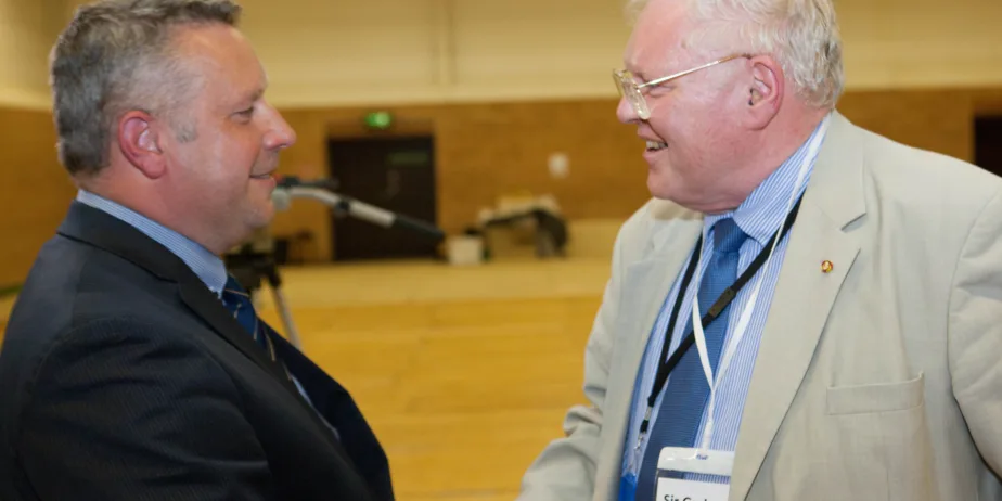 Sir Graham Bright (right) congratulating his successor Jason Ablewhite as police and crime commissioner for Cambridgeshire PHOTO: Terry Harris