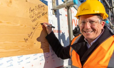 Anglian Ruskin University topping out ceremony for an extension to the Peterborough campus that will incorporate a ‘Living Lab’ public science and technology space. It will open in September. Principal Professor Ross Renton signs one of the roof panels. PHOTO: Terry Harris.