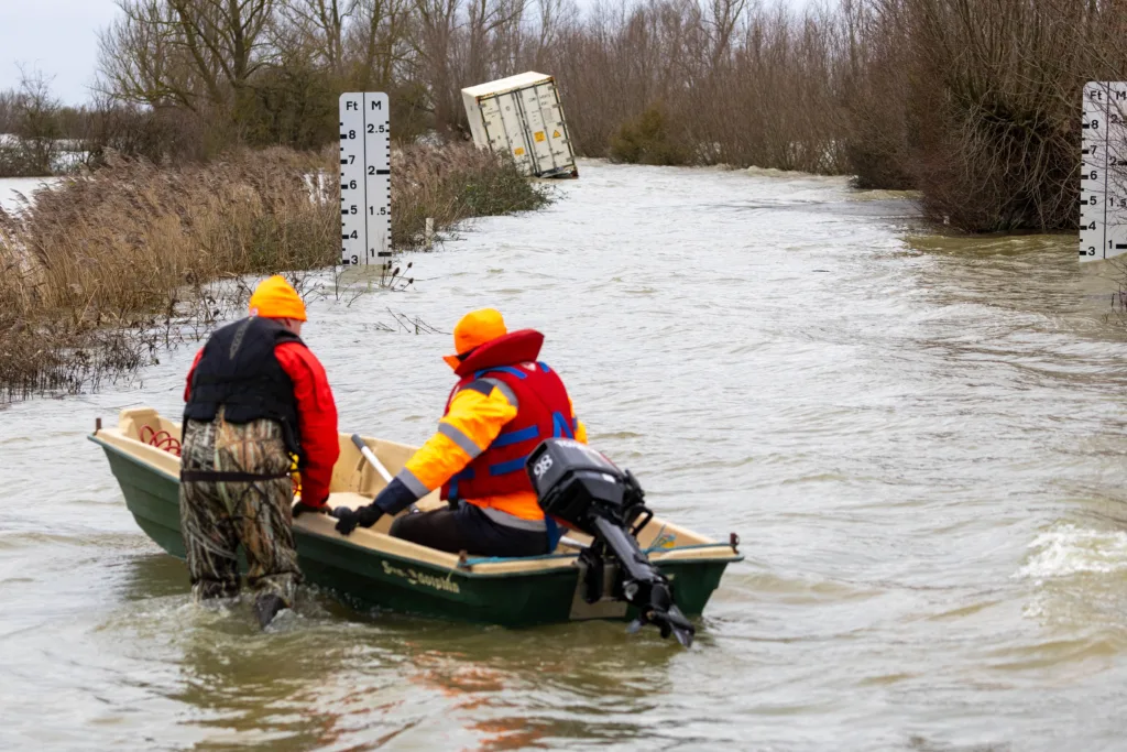 Manchetts staff weighing up the options to rescue lorry and container from flooded A1101 at Welney on the Cambridgeshire/Norfolk border. PHOTO: Terry Harris
