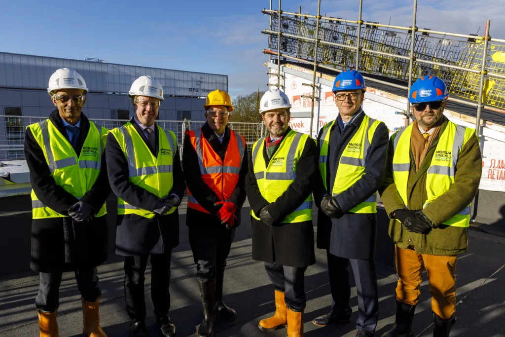 On the roof celebrating are from left Cllr Farooq, Paul Bristow MP, Prof Renton, Mayor Dr Nik Johnson, Vice Chancellor Prof Watkins and Chair of the Combined Authority Business Board, Al Kingsley