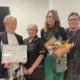 Volunteer Jet Watts receives a posthumous Outstanding Achievement Award in honour of her late husband Paul, with Rapid Responder Helen Gillies, daughter Clare Watts and Chief Nurse Jo Bennis.