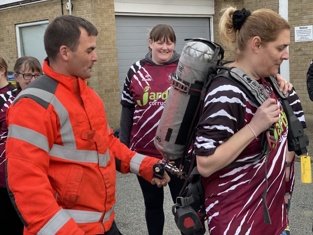 The women’s team of March Bears Rugby Club learn some basic fire fighter techniques during a visit to March Fire Station. PHOTO: Cambs Fire and Rescue