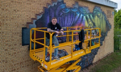 Nathan Murdoch working on a mural on the wall of the Key Theatre, Peterborough.  Embankment, Peterborough Wednesday 08 May 2024. Picture by Terry Harris.