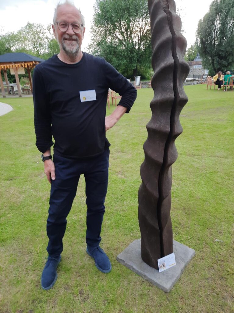 Richard Bray with a sculpture made of part of a Mulberry tree from Ramsey Abbey