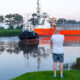 Spectators gathered by the River Nene in Wisbech as the Baltic Arrow, with its cargo of timber from Latvia, was finally freed and pulled into port. PHOTO: Terry Harris