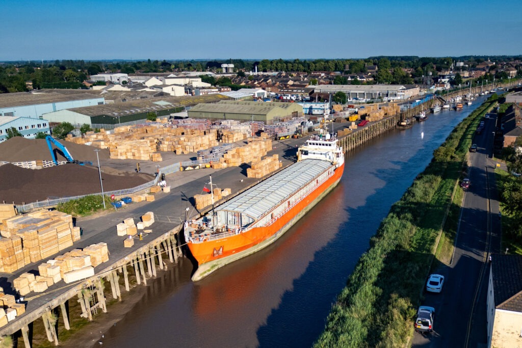 Spectators gathered by the River Nene in Wisbech as the Baltic Arrow, with its cargo of timber from Latvia, was finally freed and pulled into port. PHOTO: Terry Harris 