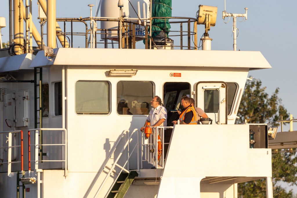 Spectators gathered by the River Nene in Wisbech as the Baltic Arrow, with its cargo of timber from Latvia, was finally freed and pulled into port. PHOTO: Terry Harris 