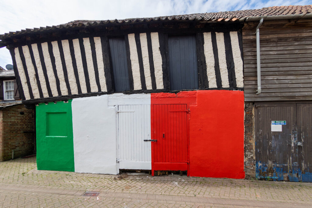 Wisbech town councillor Shahid Rafique facing an outcry after he painted a 15th century listed building red, white and green – to match the colours of his Italian Affairs restaurant 